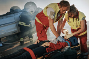 paramedics saving life of a female victim who is lying on stretchers
